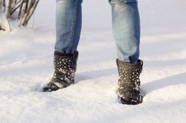 Kadının bacakları ile mavi kot pantolon ve siyah ayakkabılar bir karda