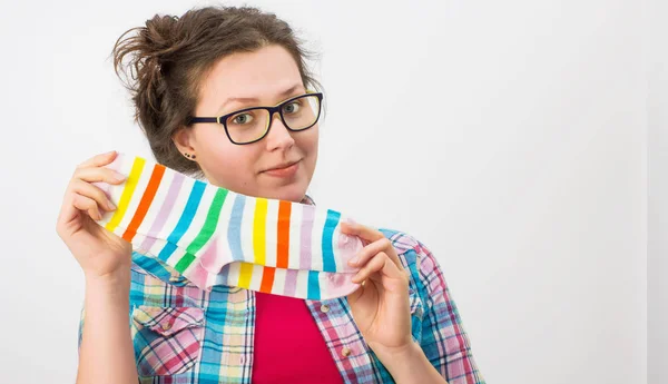 Young female holding two colorful socks — Stock Photo, Image
