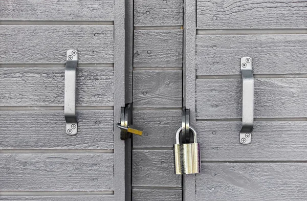 Dos cerraduras en una puerta gris de madera —  Fotos de Stock