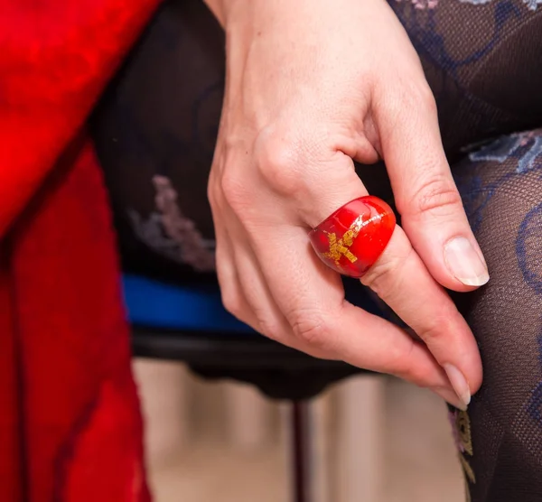 Woman's legs with beautiful stockings and hand with red ring — Stock Photo, Image