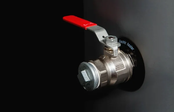 Valve with a red handle and pipe plug connected to electric heat — Stock Photo, Image