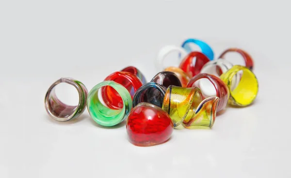 Many colorful glass rings on a white background — Stock Photo, Image