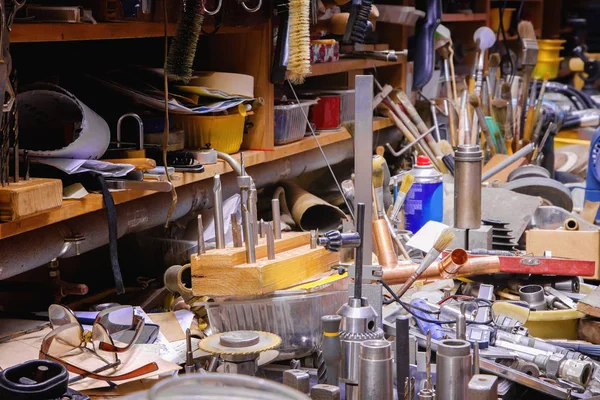 Colorful mess with various tools on a smith table