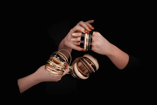 Two caucasian womans hands with golden bracelets — Stock Photo, Image