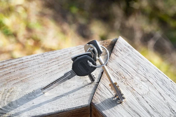 Olika nycklar med ring på en träskiva — Stockfoto