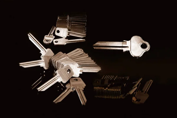 Blank metal keys on a black background — Stok fotoğraf