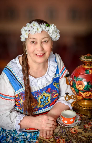Beautiful Russian woman in traditional dress. Russian style.