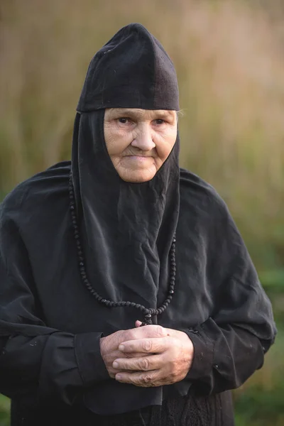 portrait of an elderly kind nun in nature
