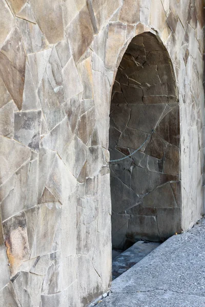 Blank arched opening in the wall of the old stone walls.