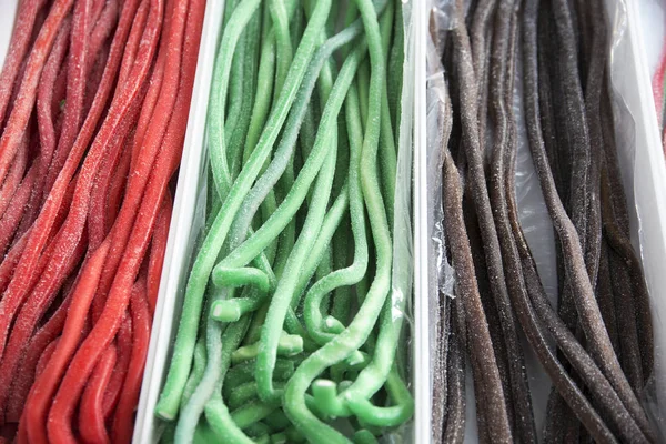 Homemade twisted colorful twisted licorice candies as a background