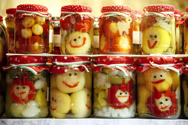 Various pickled vegetables in glass jars on retail market for sale — Stock Photo, Image