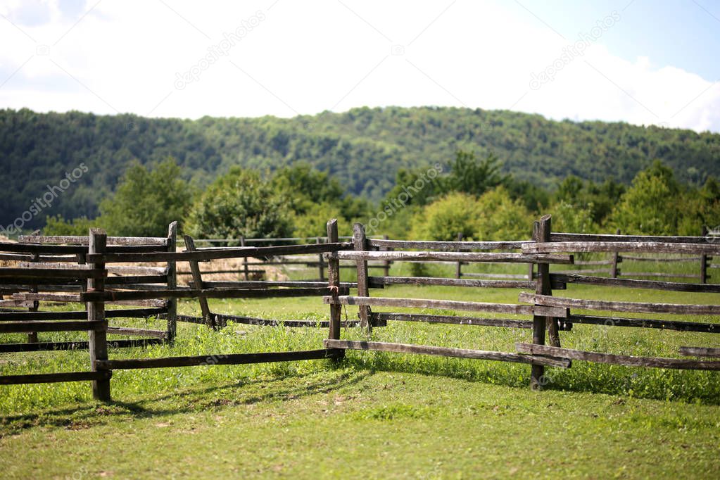 Closeup of wooden fence on a corral farmland rural scene