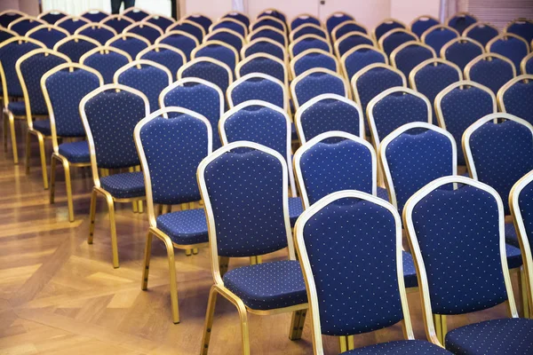 Rows of blue empty seats in unknown event hall — Stock Photo, Image