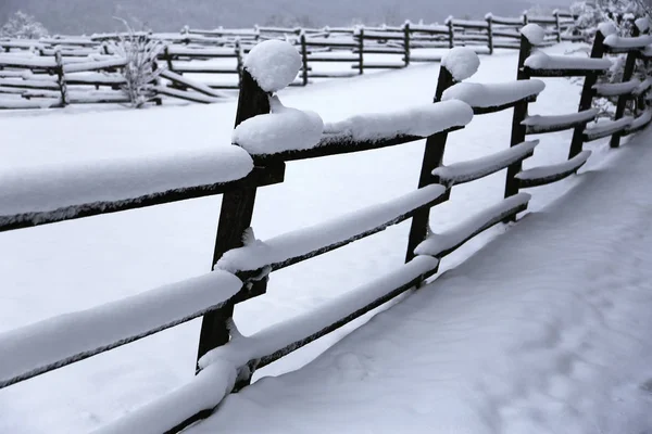 Snow filled horse corral winter time without horses