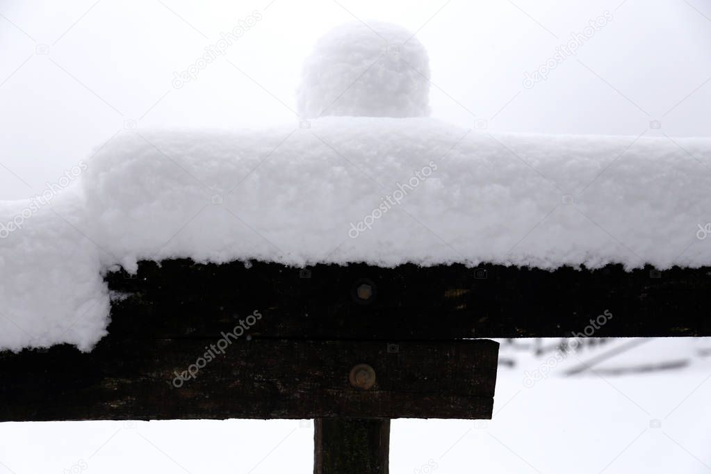 Fabulous winter landscape with fresh snow on rural wooden fence 