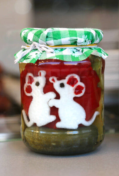 Homemade canned pickles in a jars at christmastime as a gift
