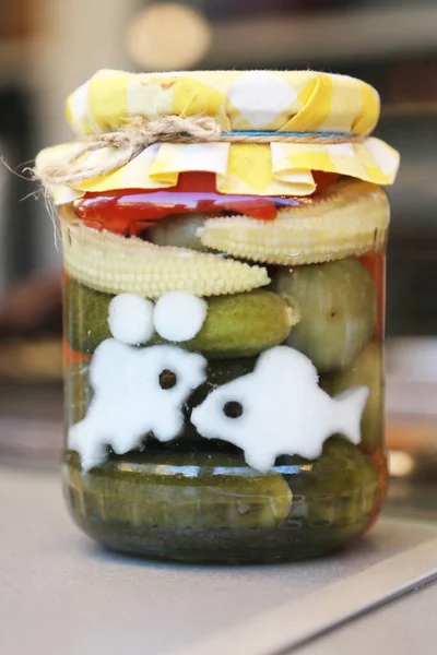 Funny preserves vegetables in glass jars. — Stock Photo, Image