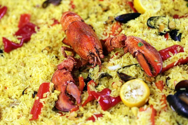 Plate of clawed lobster with yellow rice