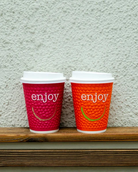 two cups of coffee on the table with wall background
