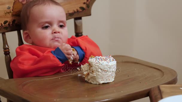 Малыш ест торт на день рождения — стоковое видео