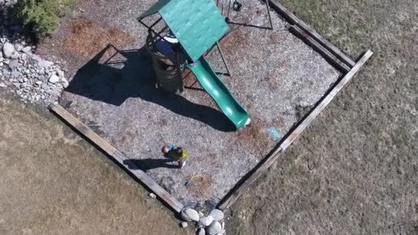 Aerial shot of family playing on a playset — Stock Video