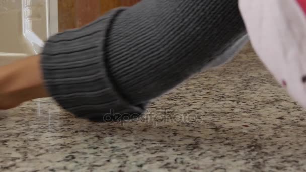 Женщина чистит кухонный гранитный прилавок — стоковое видео