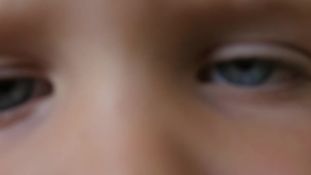 Boy with amazing eyes stares into camera — Stock Video