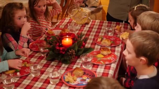 Діти їдять на різдвяній вечері — стокове відео
