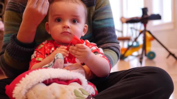 Baby looking through Christmas stocking — Stock Video