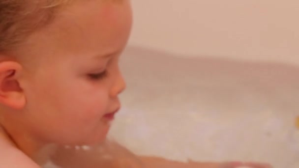 Cute little boy in bathtub with toys — Stock Video