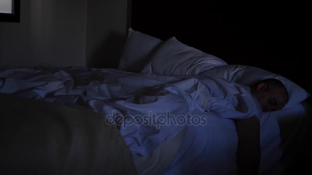 Un uomo esaltato addormentato in un letto d'albergo — Video Stock