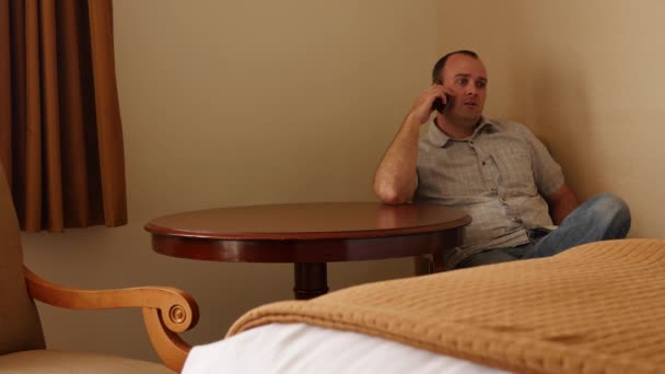 Mann telefoniert im Hotelzimmer — Stockvideo