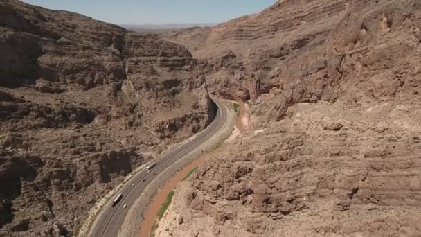 Bilar som kör genom öknen canyon bredvid floden — Stockvideo