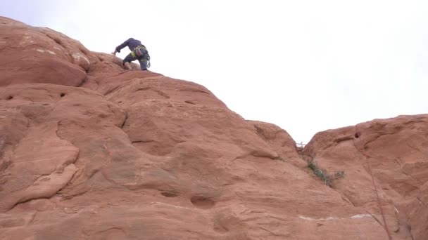 Homem escalando redrock em Moab — Vídeo de Stock