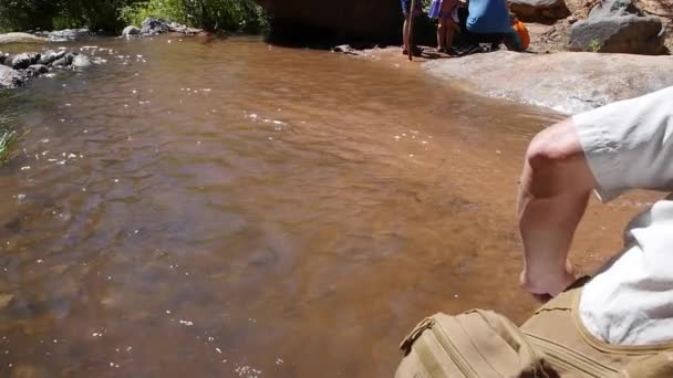 Homem pulando pedras em um riacho do deserto — Vídeo de Stock