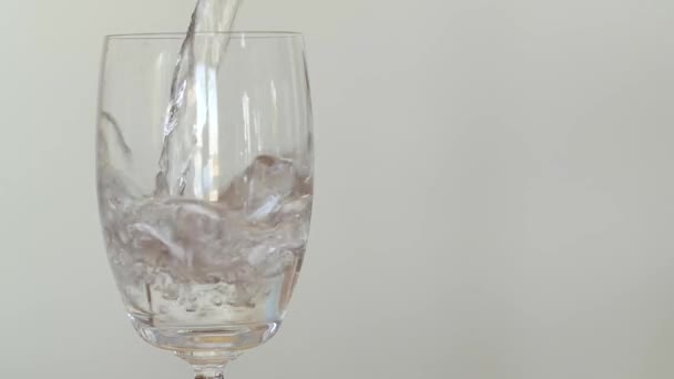 Pouring a glass of clear water from a pitcher — Stock Video