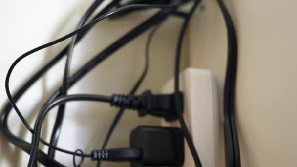 Tons of plugs and cables in surge protector — Stock Video