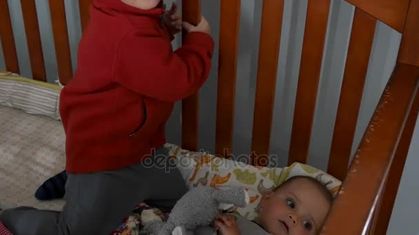 Boys playing in a crib together — Stock Video