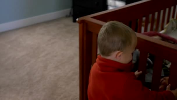 Boys playing in a crib together — Stock Video