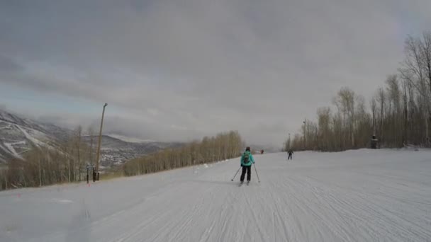 Woman skiing down mountain resort hill — Stock Video