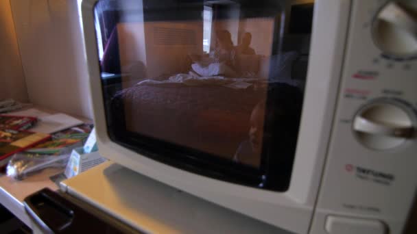 A family cooking pizza in hotel microwave — Stock Video