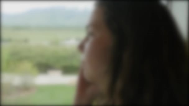 A girl staring out window at view — Stock Video