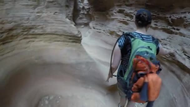 A mother and newborn hiking slot canyon — Stock Video