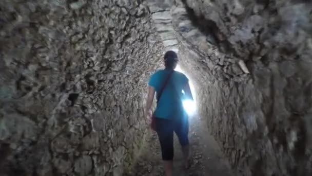 A woman in ancient Mayan tunnel at Coba — Stock Video