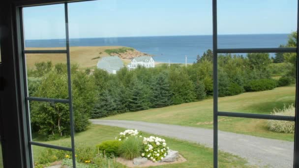 Dolly shot of a window and Cape Breton coastline — Stock Video