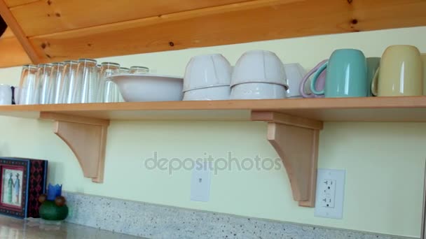 Cups on a shelf in home — Stock Video