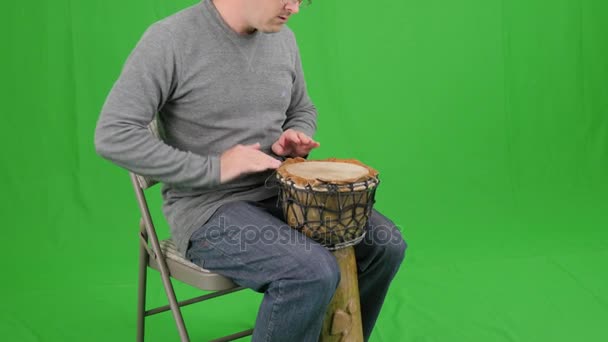 Человек играет на деревянном барабане — стоковое видео