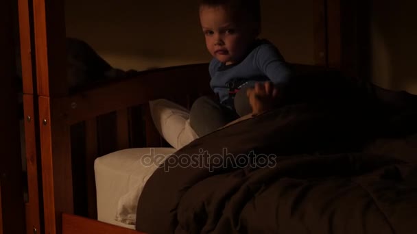 Boy listens to grandpa tell a story while in bed — Stock Video