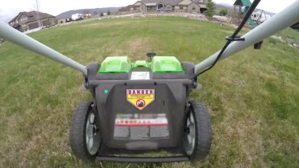 Mowing lawn with electric mower — Stock Video