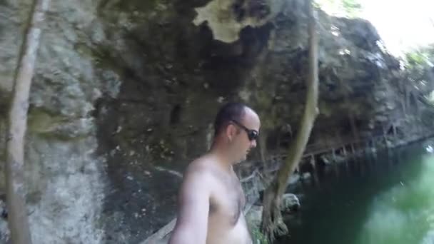 Man jumps into a cenote at Ek Balaam — Stock Video